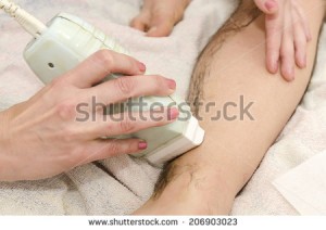 stock-photo-beautician-while-making-a-male-waxing-with-wax-strips-206903023