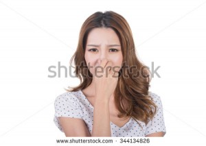 stock-photo-portrait-of-a-young-woman-holding-her-nose-because-of-a-bad-smell-344134826
